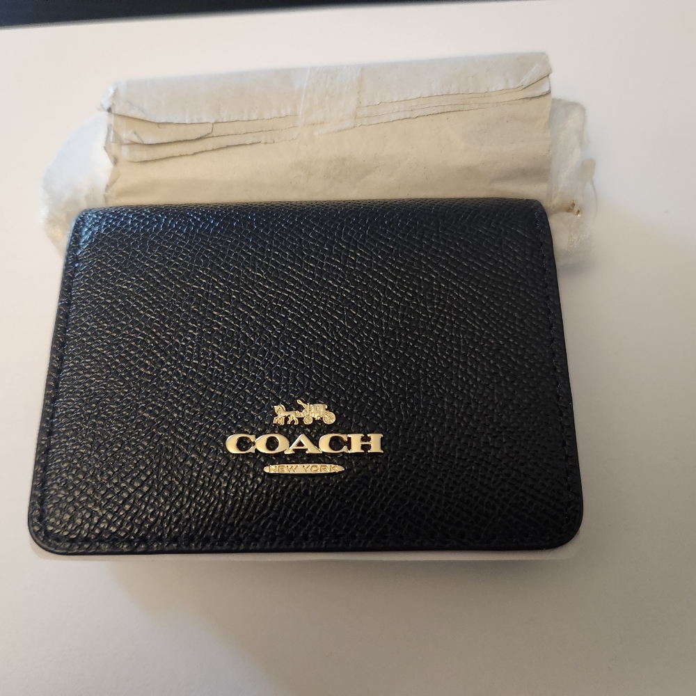 Coach mini wallet on a chain.